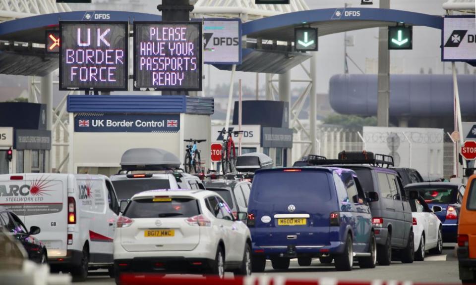 People queue in line to check-in for the cross channel ferry in Calais, France.