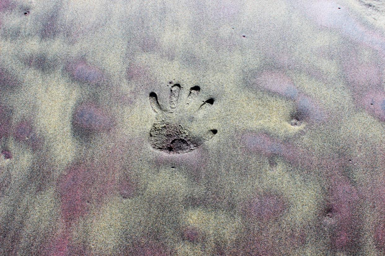 Handprint in Pfeiffer beach purple sand on holiday