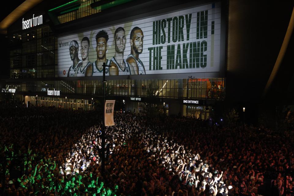 Fans watch television coverage of the Milwaukee Bucks and Phoenix Suns playing in Game 6 of the NBA basketball finals Tuesday, July 20, 2021, in Milwaukee. (AP Photo/Jeffrey Phelps)
