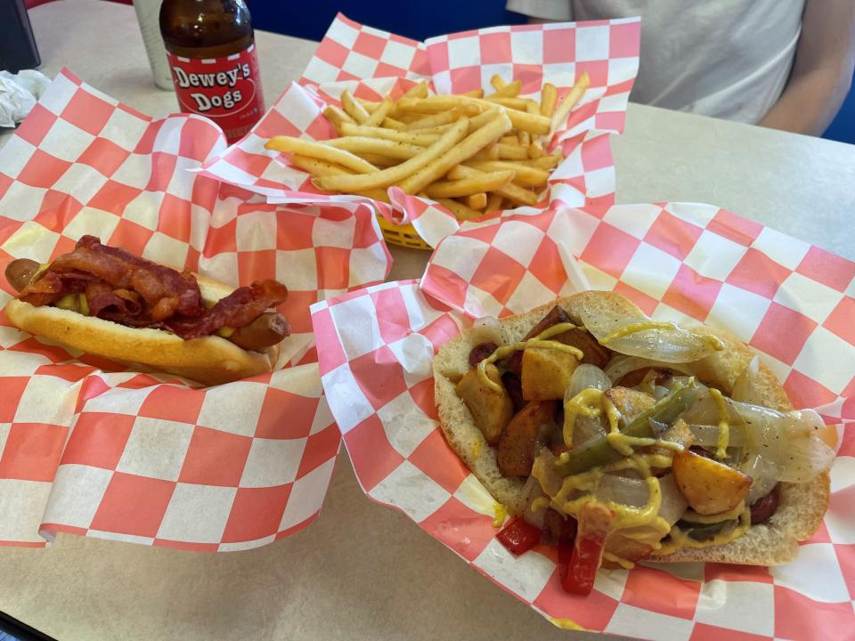 A hot dog with bacon, french fries and an Italian hot dog at Dewey's Dogs in the Forked River section of Lacey.