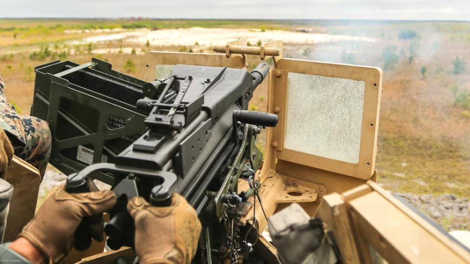 A Marine fires a 40x53mm Mk 19 Mod 3 automatic grenade launcher mounted on a Humvee during training. <em>USMC</em>