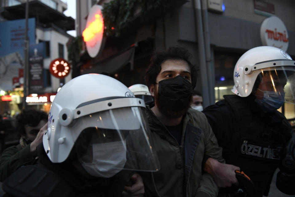 Turkish police officers arrest a youth during clashes with students of the Bogazici University protesting the appointment of a government loyalist to head their university, in Istanbul, Tuesday, Feb. 2, 2021. For weeks, students and faculty at Istanbul's prestigious Bogazici University have been protesting President Recep Tayyip Erdogan's appointment of Melih Bulu, a figure who has links to his ruling party, as the university's rector. They have been calling for Bulu's resignation and for the university to be allowed to elect its own president. (AP Photo/Omer Kuscu)