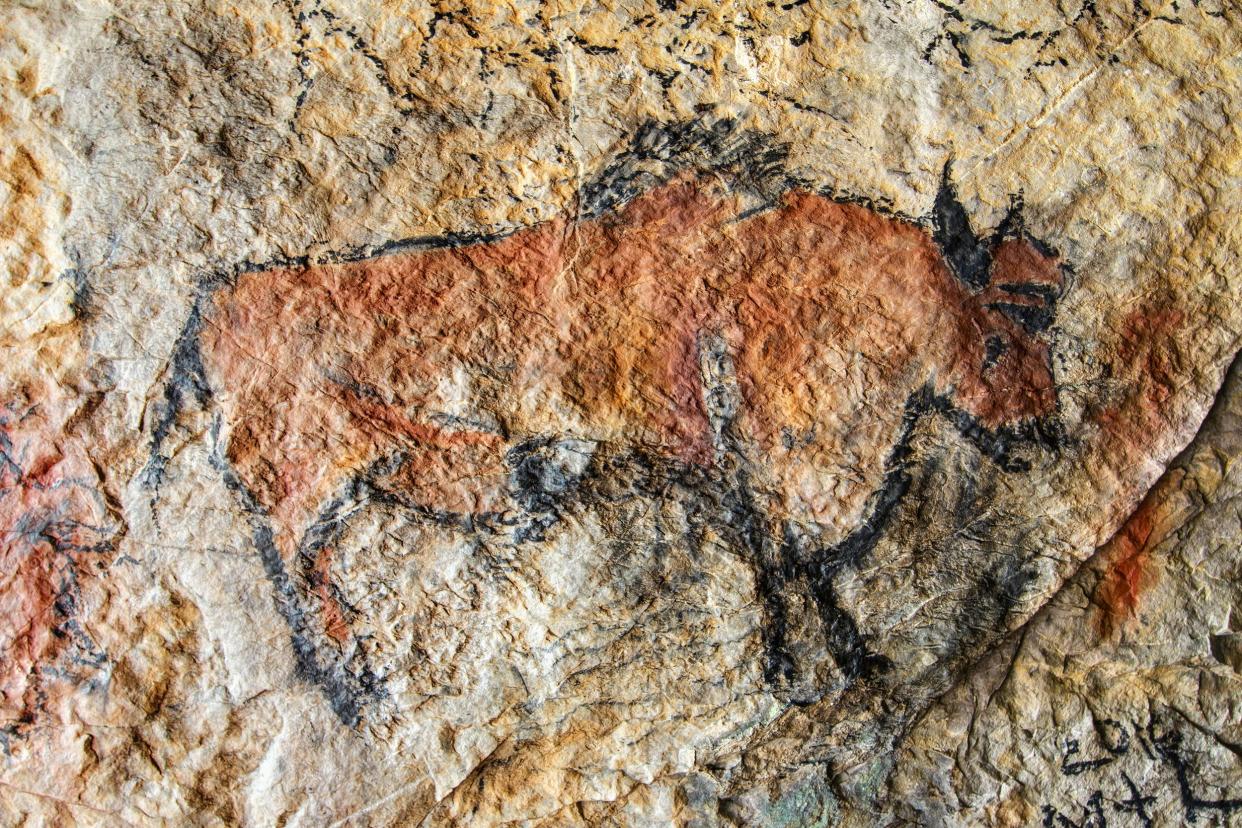 cave painting of bull in prehistoric style