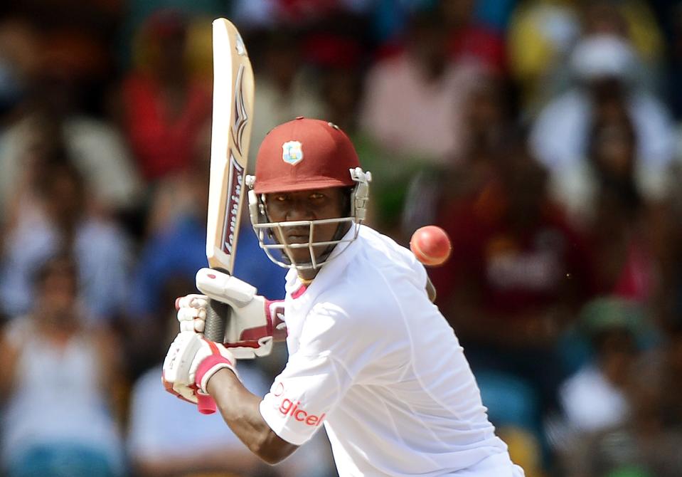 West Indies cricket team captain Darren Sammy hits a boundary off Australian bowler Ben Hilfenhaus during the second day of the first-of-three Test matches between Australia and West Indies at the Kensington Oval stadium in Bridgetown on April 8, 2012. AFP PHOTO/Jewel Samad (Photo credit should read JEWEL SAMAD/AFP/Getty Images)