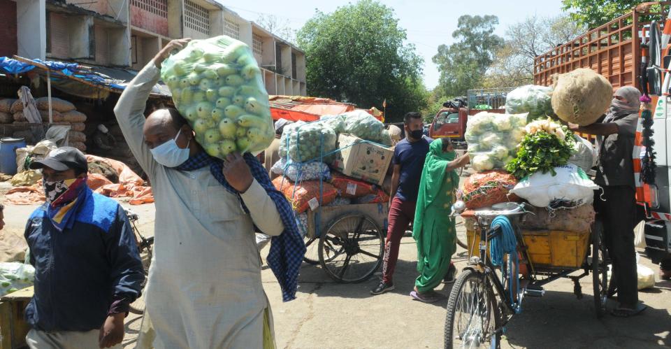 CHANDIGARH, INDIA - APRIL 8:  Vendors with vegetables purchased for sale, on day fifteen of the 21-day nationwide lockdown to check the spread of coronavirus, at Sabzi Mandi Sector 26   on April 8, 2020 in Chandigarh, India.  (Photo by Keshav Singh/Hindustan Times via Getty Images)