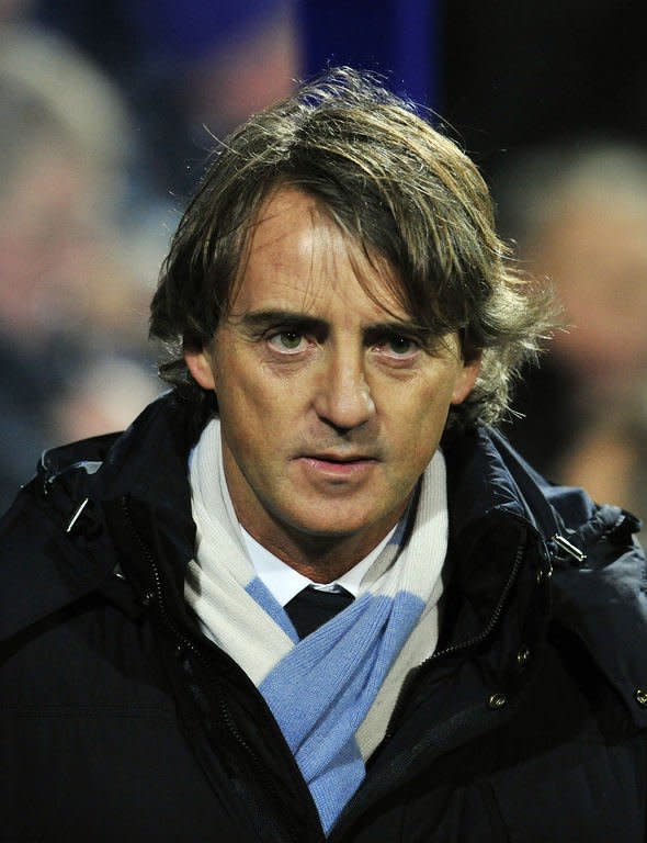 Manchester City's Italian manager Roberto Mancini looks on before the English Premier League football match between Queens Park Rangers and Manchester City at Loftus Road in London, England on January 29, 2013