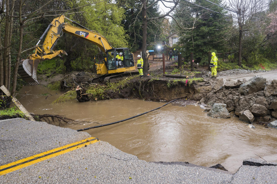 Crews assess storm damage, which washed out North Main Street in Soquel, Calif., Friday, March 10, 2023. (AP Photo/Nic Coury)