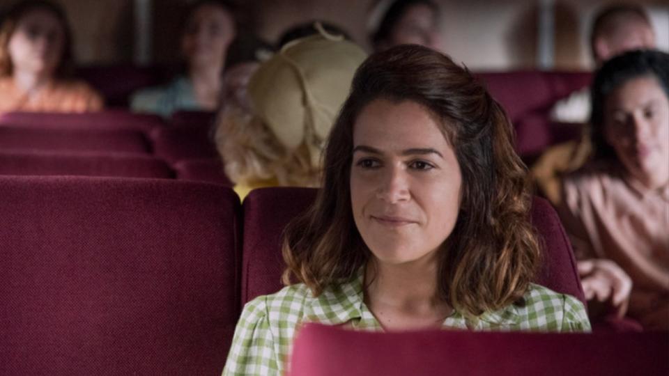 Carson smiling while sitting in a theater