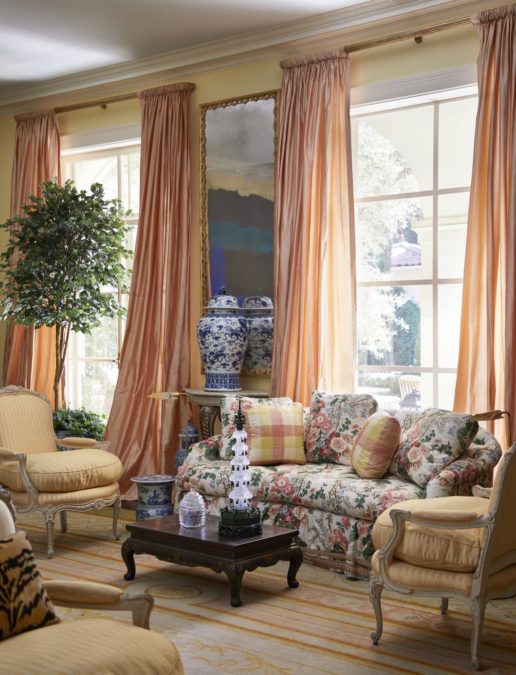 the living room in soft sunset palette originated with an antique spanish rug