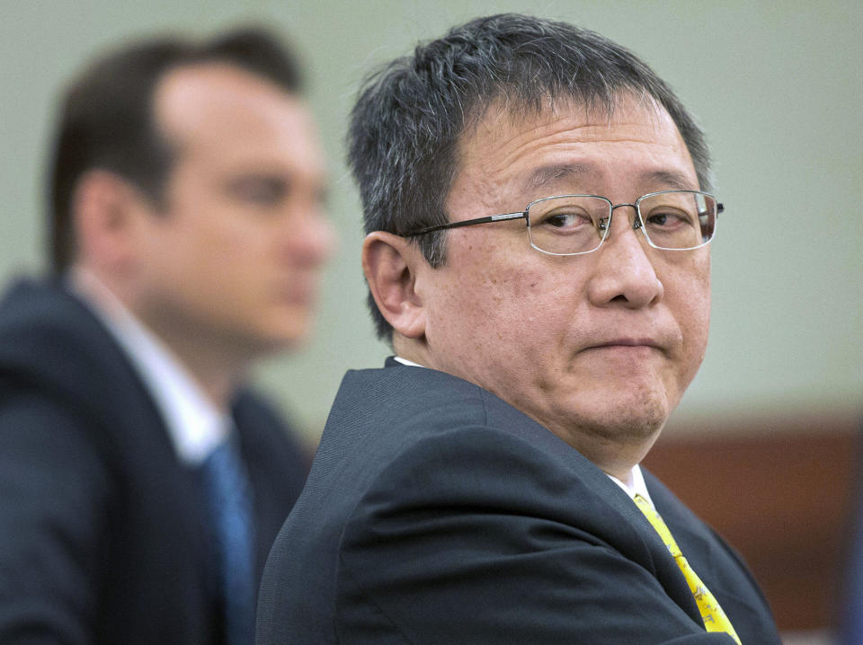 FILE - In this April 4, 2013, file photo, Hong Kong businessman Richard Suen, right, waits as counsel addresses the judge during a trial against the Las Vegas Sands Corp., in Clark County district court in Las Vegas. Jurors considering how much Suen should receive from Las Vegas Sands Corp. for help opening its first casino in Macau 15 years ago are seeing videotaped testimony from ailing billionaire Sands chief Sheldon Adelson. Attorneys for Sands argue that Richard Suen should get a fraction of the $347 million he's seeking in a long-fought breach-of-contract lawsuit. (AP Photo/Julie Jacobson, File)