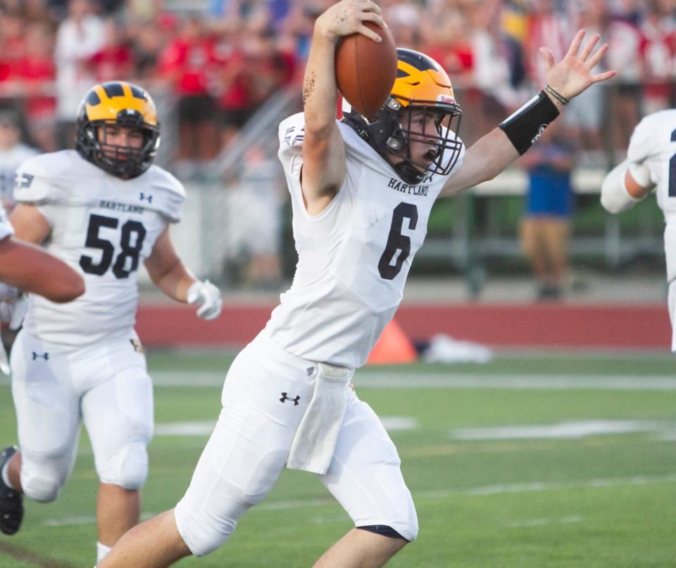 Hartland quarterback James Butzier celebrates his 5-yard touchdown run before halftime in a 13-10 loss at Novi on Thursday, Sept. 1, 2022.