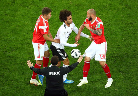 Soccer Football - World Cup - Group A - Russia vs Egypt - Saint Petersburg Stadium, Saint Petersburg, Russia - June 19, 2018 Egypt's Amr Warda clashes wih Russia's Andrey Lunyov REUTERS/Michael Dalder