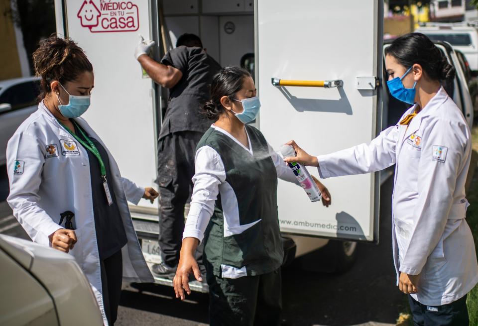 A health brigade gets ready while on door-to-door visits to carry out COVID-19 tests in Mexico City, on June 16, 2020, amid the new coronavirus pandemic. (Photo by PEDRO PARDO / AFP) (Photo by PEDRO PARDO/AFP via Getty Images)