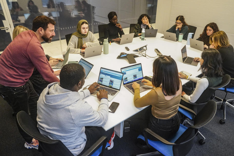 Slade Sohmer, standing left, editor at the news video company Recount, conducts a workshop for reporters at The News Movement (TNM), a social media news operation re-imagined for Gen-Z consumers, Wednesday, March 1, 2023, in New York. TNM, which uses a staff of reporters with an average age of 25 to make tailored news content for sites like TikTok, Instagram, YouTube and Twitter, has bought the Recount. (AP Photo/Bebeto Matthews)