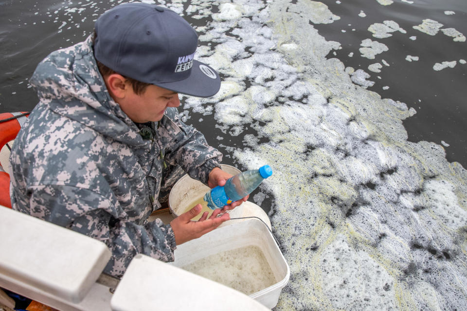 A man collects water samples from Avacha Bay off the Kamchatka Peninsula, after a mass die-off of marine animals, with the local authorities reporting sea water pollution. / Credit: Yelena Vereshchaka/TASS via Getty Images