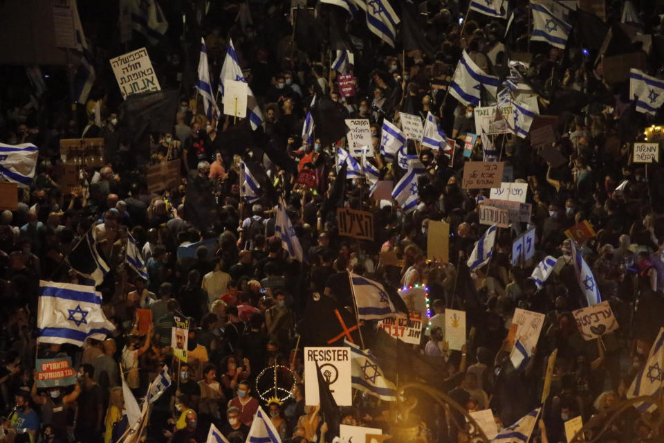 Thousands protest against Israel's Prime Minister Benjamin Netanyahu in front of his official residence in Jerusalem, Saturday, Aug. 8, 2020. (AP Photo/Ariel Schalit)