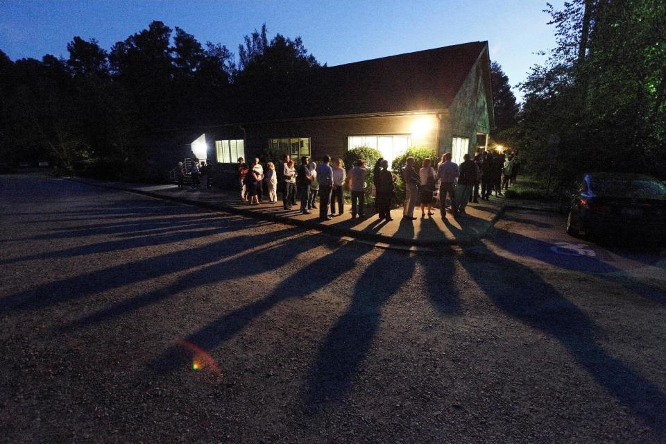 Voters cast shadows as they wait in a line at a polling station open into the evening as early voting for the 2016 general elections begins in Durham, North Carolina, U.S., October 20, 2016. REUTERS/Jonathan Drake TPX IMAGES OF THE DAY