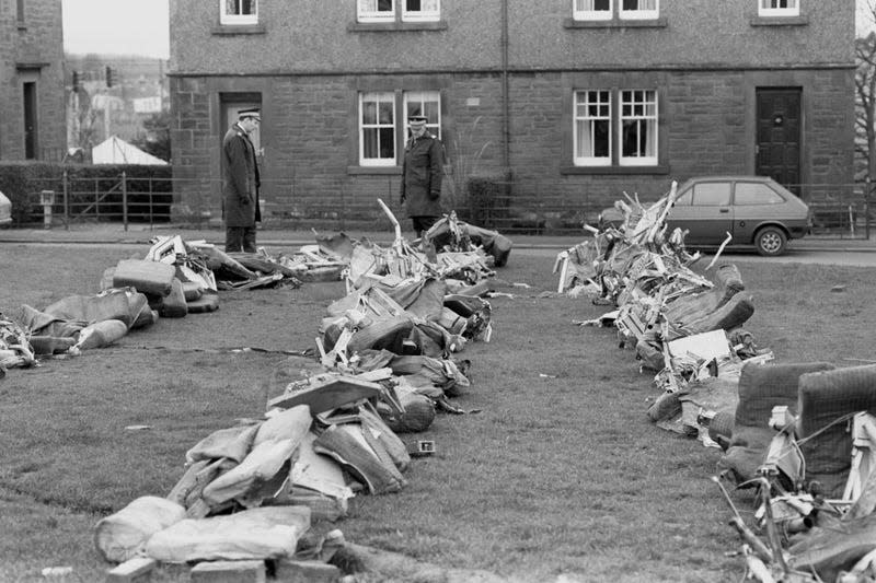 Police officers view a row of aircraft seats from the crashed Pan Am Boeing 103. 