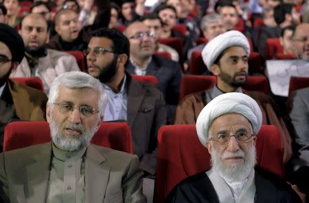 Ayatollah Ahmad Jannati (R), a candidate for the upcoming vote on the Assembly of Experts, and Iran's former chief negotiator Saeed Jalili attend a conservatives election campaign gathering in Tehran February 24, 2016. The campaign gathering was titled "No to UK Meddling". REUTERS/Raheb Homavandi/TIMA