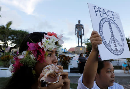 A Guamenian blows on a shell horn, locally called "Kulu", during a peace rally at Chief Quipuha Park, on the island of Guam, a U.S. Pacific Territory, August 14, 2017. REUTERS/Erik De Castro