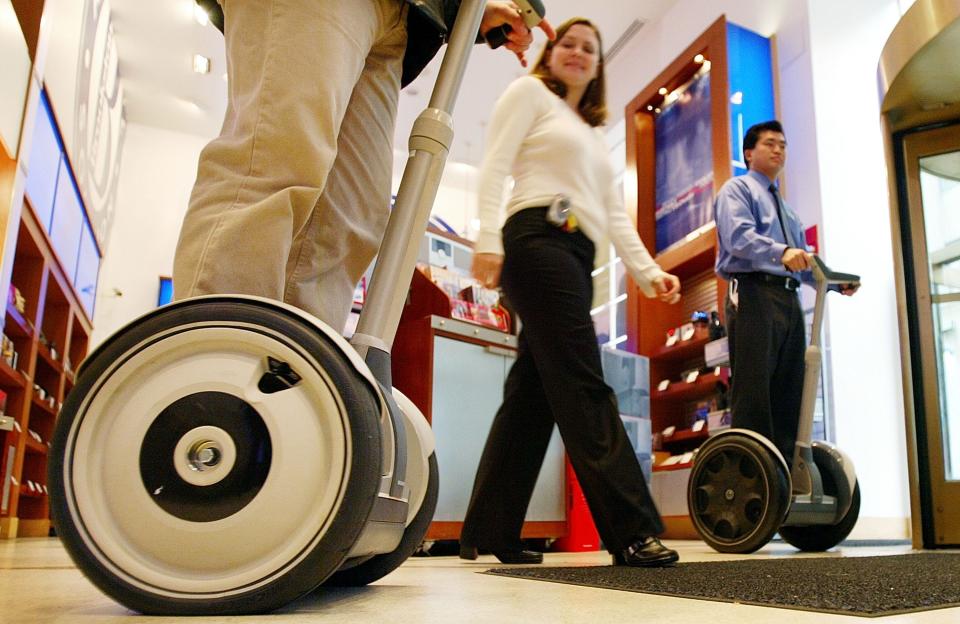 Riders try out Segways in 2003 in a Brookstone store after the company announced today that Brookstone would be the first and only national retail store chain to sell the device.