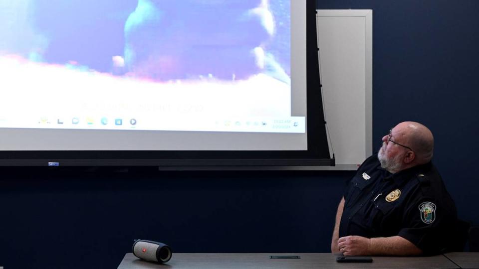 A Palmetto Police officer watches video during a press conference to release the body camera footage from Nov. 1, 2023, when police arrested Breonte Johnson-Davis after he was accused of acting aggressively towards customers at a convenience store.
