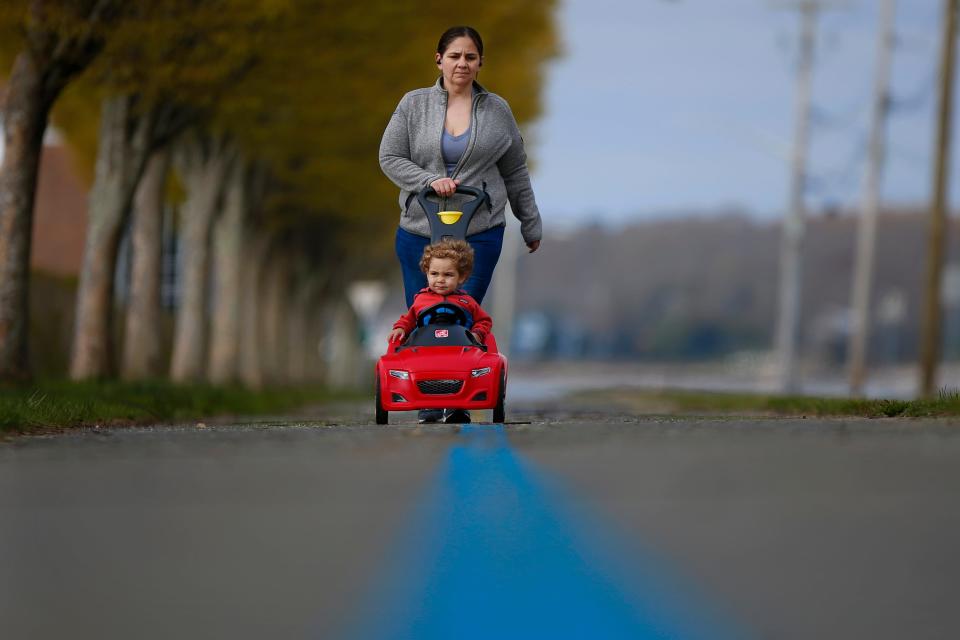 Casey Cabral and her son Maxwell Cabral, 1, go for a walk along the Blue Lane walk path around the south end of New Bedford.