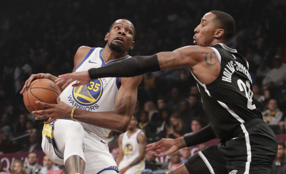 FILE - In this Oct. 28, 2018, file photo, Brooklyn Nets' Caris LeVert (22) defends against Golden State Warriors' Kevin Durant during the first half of an NBA basketball game in New York. Durant and Kyrie Irving gave the Nets two big victories in one night. In the first hours of free agency, the team added two of the best players available to a young roster that made the playoffs, giving them hope of not only contention for an NBA title, but to be the biggest basketball team in New York. (AP Photo/Frank Franklin II, File)