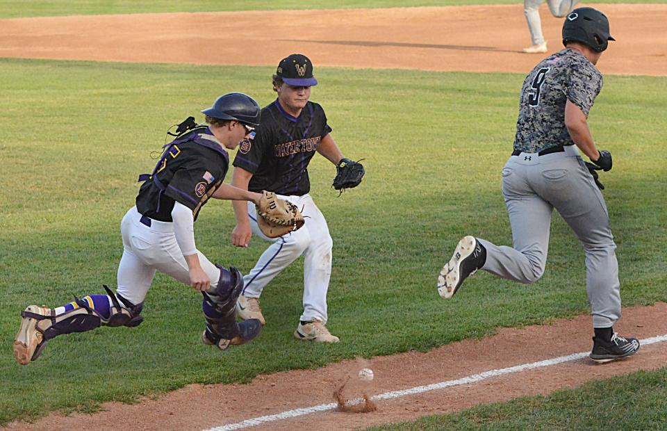 Aberdeen Smittys base runner Ethan Kjenstad runs to first while Watertown Post 17 catcher Carson Mutschler (left) and pitcher Kaden Rylance chase after a grounder during Game 1 of their best-of-three American Legion Baseball regional playoff series on Thursday, July 20, 2023 at Watertown Stadium. Aberdeen won 15-4.