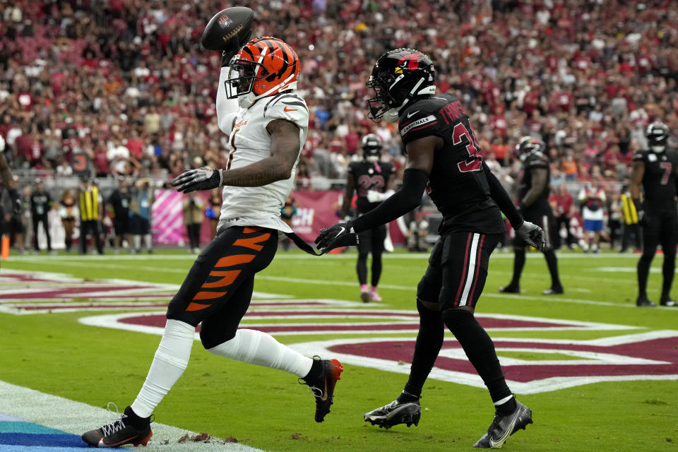 Cincinnati Bengals wide receiver Ja'Marr Chase celebrates his touchdown as Arizona Cardinals safety Jalen Thompson, right, defends during an NFL football game, Sunday, Oct. 8, 2023, in Glendale, Ariz. (AP Photo/Rick Scuteri)