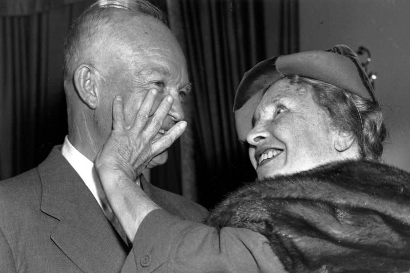 Blind and deaf author Helen Keller, who died on this day in 1968, runs her fingers over the face of President Dwight Eisenhower during a visit to the White House in 1953. File Photo by Charles Corte/UPI