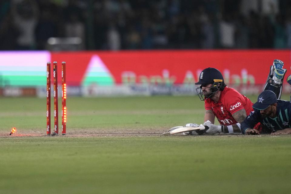 England's Reece Topley, second right, reacts after he run out by Pakistan's Shan Masood, right, during the fourth twenty20 cricket match between Pakistan and England, in Karachi, Pakistan, Sunday, Sept. 25, 2022. (AP Photo/Anjum Naveed)