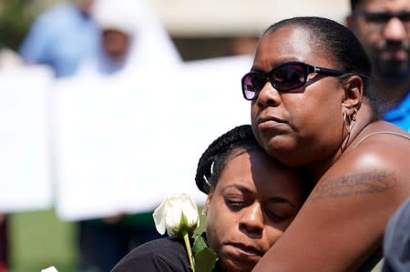 Mourners gather and pray during a vigil after a mass shooting in Dayton