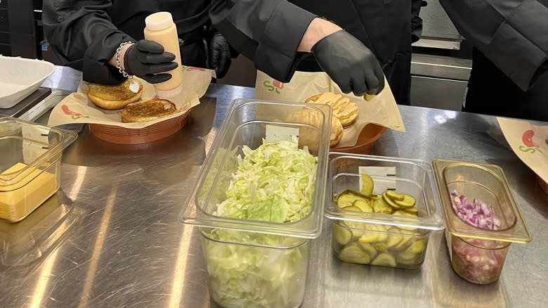 Burgers being assembled in kitchen