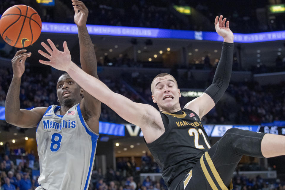 Memphis forward David Jones (8) reaches for a rebound next to Vanderbilt forward Tason Kamateros (21) during the second half of an NCAA college basketball game Saturday, Dec. 23, 2023, in Memphis, Tenn. (AP Photo/Nikki Boertman)