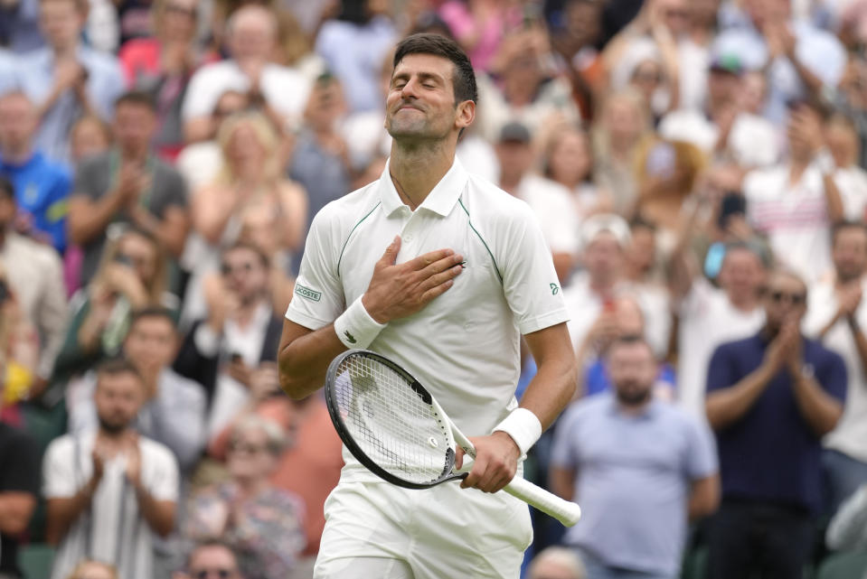 Serbia's Novak Djokovic celebrates after beating Korea's Kwon Soonwoo in a men's first round singles match on day one of the Wimbledon tennis championships in London, Monday, June 27, 2022. (AP Photo/Kirsty Wigglesworth)