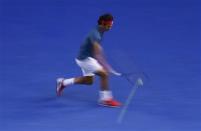 Roger Federer of Switzerland hits a return to Rafael Nadal of Spain during their men's singles semi-final match at the Australian Open 2014 tennis tournament in Melbourne January 24, 2014. REUTERS/David Gray