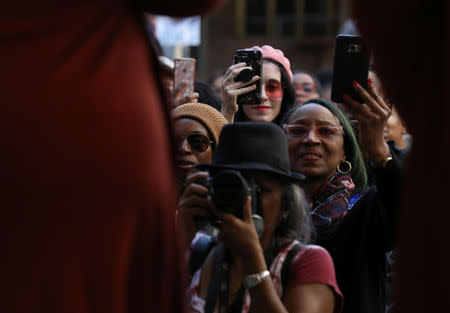 Stacey Abrams supporters take photos of the Democratic gubernatorial candidate for Georgia with their cell phones and cameras as she speaks to a crowd at the Atlanta Underground in Atlanta, Georgia, U.S., ahead of the midterm elections, October 28, 2018. REUTERS/Lawrence Bryant