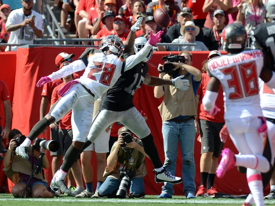 Oct 30, 2016; Tampa, FL, USA; Tampa Bay Buccaneers defensive back Vernon Hargreaves III (28) breaks up a pass intended for Oakland Raiders wide receiver Michael Crabtree (15) in the first half  at Raymond James Stadium. Mandatory Credit: Jonathan Dyer-USA TODAY Sports