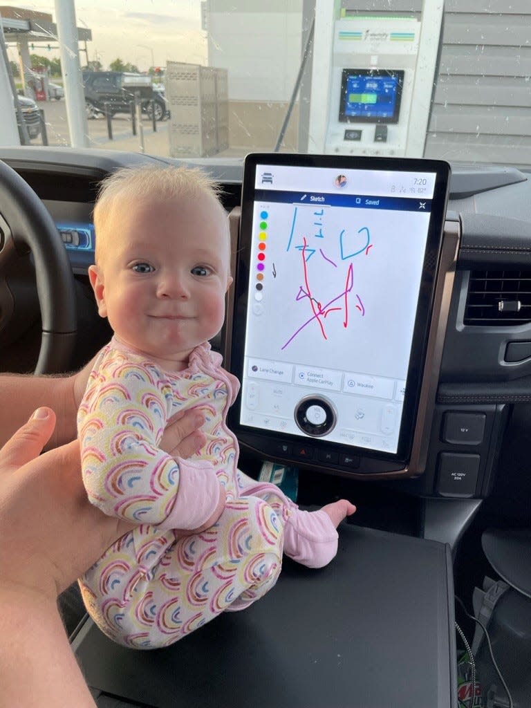 MacKenzie Jaehnert of Richland, Washington, rides in her family's all-electric Ford F-150. Here she is seen on Aug. 26, 2022 playing with a “Sketch” program that’s integrated into Ford’s navigation/infotainment system. While in park, MacKenzie can draw and doodle. She made the designs with her tiny toes while the vehicle charged during a trip to Wisconsin.