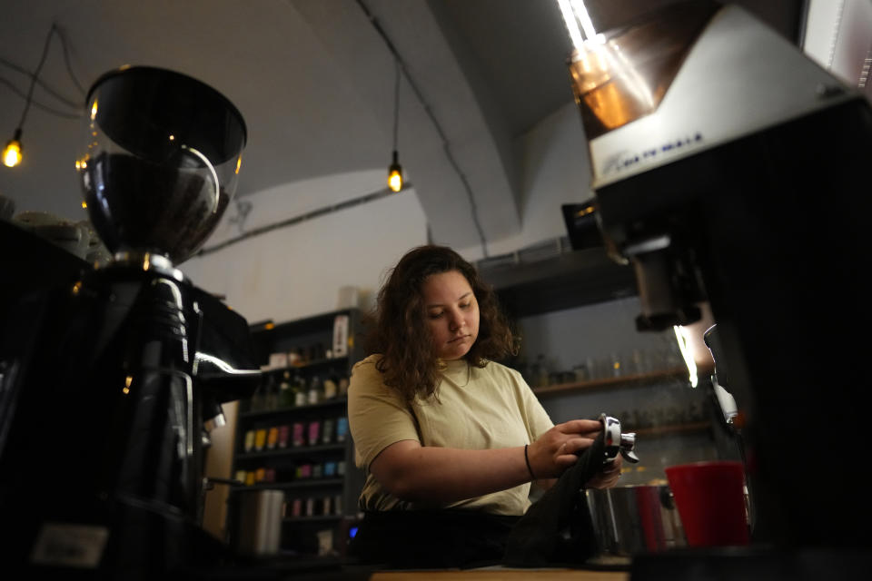 Ukranian refugee Lisa Himich prepares a coffee at a shop where she works, Friday, July 15, 2022, in Prague, Czech Republic. Nearly six months after the Russian invasion of Ukraine, many refugees are still struggling to find jobs in their European Union host countries, despite the EU's streamlined process for Ukrainians to live and work in any of its 27 member nations. (AP Photo/Petr David Josek)