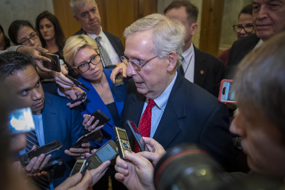 Senate Majority Leader Mitch McConnell, R-Ky., is met by reporters as he returns to the Capitol from the White House as work to avoid a partial government shutdown continues with President Donald Trump demanding funds for a border wall, at the Capitol in Washington, Friday, Dec. 21, 2018. Trump is imploring McConnell to change the Senate's rules in order to pass the spending bill. (AP Photo/J. Scott Applewhite)