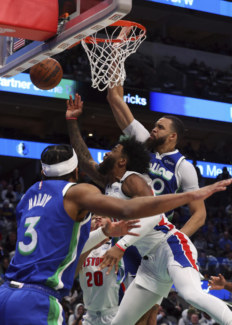 Detroit Pistons forward Saddiq Bey, center, shoots against Dallas Mavericks center JaVale McGee, right, and guard Jaden Hardy (3) in the first half of an NBA basketball game Monday, Jan. 30, 2023, in Dallas. (AP Photo/Richard W. Rodriguez)