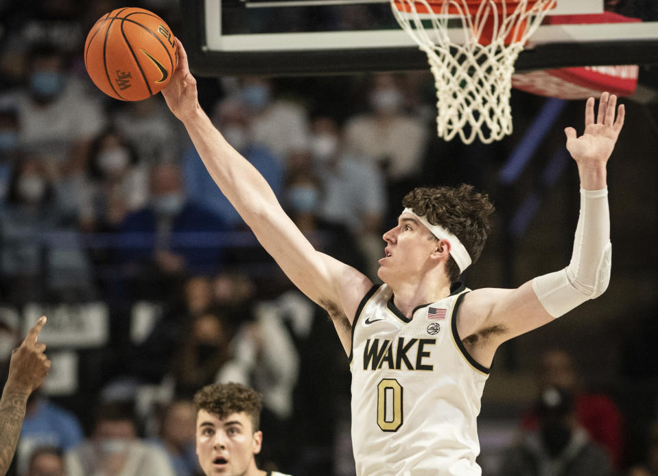 Wake Forest forward Jake Laravia (0) blocks a North Carolina shot during the first half of an NCAA college basketball game Saturday, Jan. 22, 2022, in Winston-Salem, N.C. (Allison Lee Isley/The Winston-Salem Journal via AP)