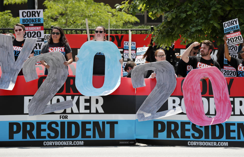 Supporters for Democratic presidential candidate Cory Booker hold signs outside the Iowa Democratic Party's Hall of Fame Celebration, Sunday, June 9, 2019, in Cedar Rapids, Iowa. (AP Photo/Charlie Neibergall)