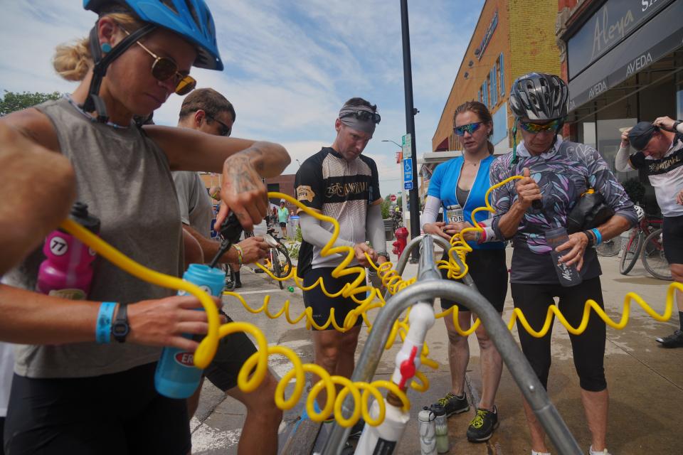 Riders get sprayed with water as they roll into Newton as RAGBRAI 50 rolls toward Tama-Toledo on Day 5 of the ride on Thursday, July 27, 2023.