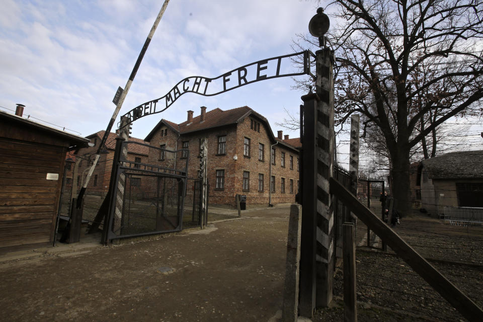 FILE - In this Jan. 27, 2020 file photo, writing reading in German "Work Sets You Free" is seen on the gate of the Auschwitz Nazi death camp in Oswiecim, Poland. Police and prosecutors in southern Poland were investigating on Wednesday, Oct. 6, 2021, English and German language graffiti found on the barracks of the former Nazi German death camp of Auschwitz-Birkenau. (AP Photo/Markus Schreiber, file)