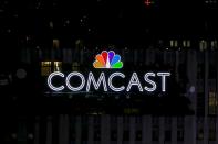 FILE PHOTO: The NBC and Comcast logo are displayed on top of 30 Rockefeller Plaza, formerly known as the GE building, in midtown Manhattan in New York