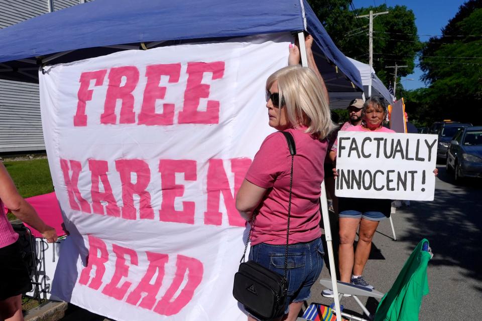 Supporters of Karen Read display signs and a banner a block away from Norfolk Superior Court, Tuesday, June 25, 2024, in Dedham, Mass. Karen Read is on trial, accused of killing her boyfriend Boston police Officer John O'Keefe, in 2022. (AP Photo/Steven Senne)