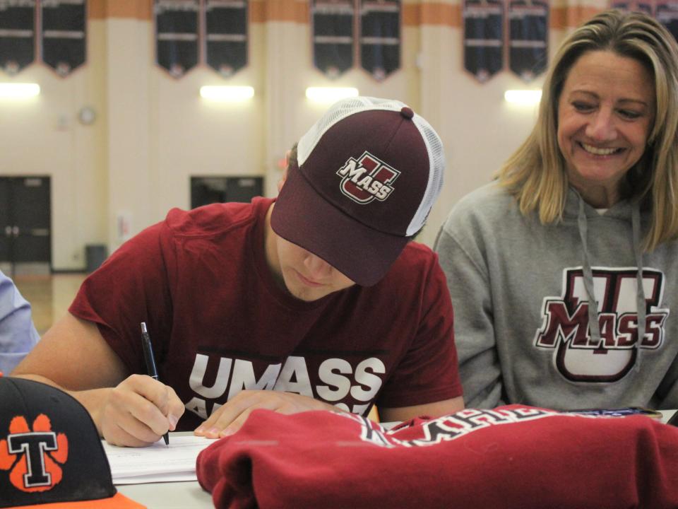 Taunton baseball's Braden Sullivan signs his National Letter of Intent to play for the University of Massachusetts as mom Lisa Sullivan watches on during a signing ceremony on Nov. 14, 2022.